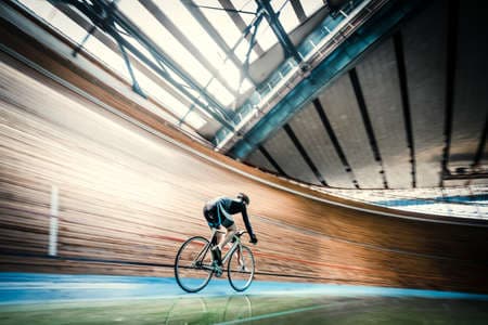 Athlete on a bicycle on velodrome